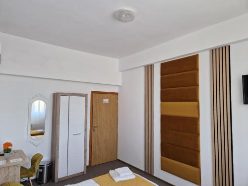 a room with a door and a table and chair at ANTIK HOUSE in Cornu de Jos