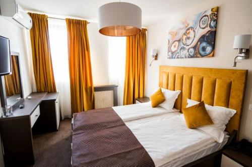 a hotel room with a bed and a television at Praya Boutique in Slatina