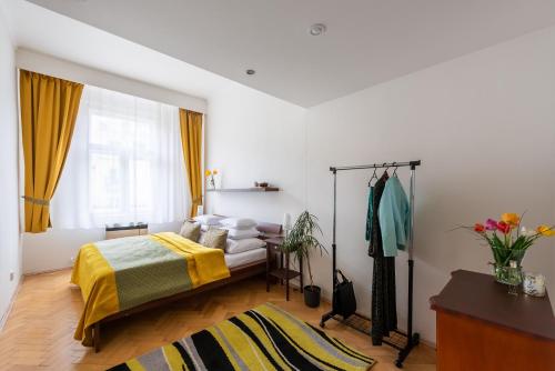 a bedroom with a bed with a yellow blanket at Prague - Karlin Apartments in Prague