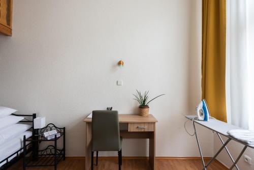 a bedroom with a desk and a bed and a desk and chair at Prague - Karlin Apartments in Prague