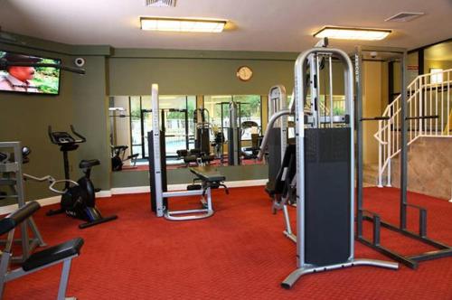 a gym with several treadmills and equipment on a red carpet at Jockey Club Suites in Las Vegas