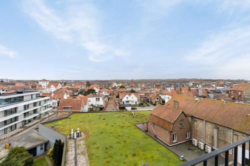 a group of people standing on a green field in a city at Viviane - Beautifull view, Garage, 200m from beach in De Panne