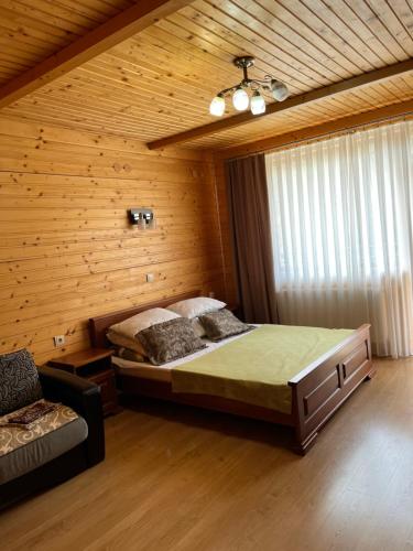 a bedroom with a bed in a wooden room at "Діброва" in Yaremche