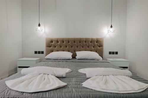 a bedroom with a large bed with two white pillows at Iphigenia Luxury Flat in Sarandë
