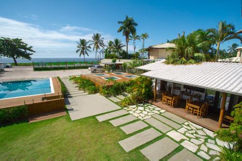 an aerial view of a house with a swimming pool at Tropical Beach in Porto Seguro