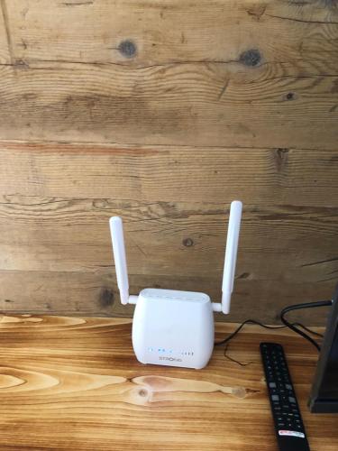 a white router sitting on top of a wooden desk at Baita Poira in Mello