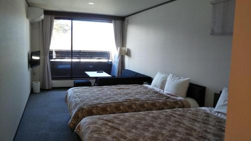 a hotel room with two beds and a window at KAINOSATO - Vacation STAY 08807v in Azagawa