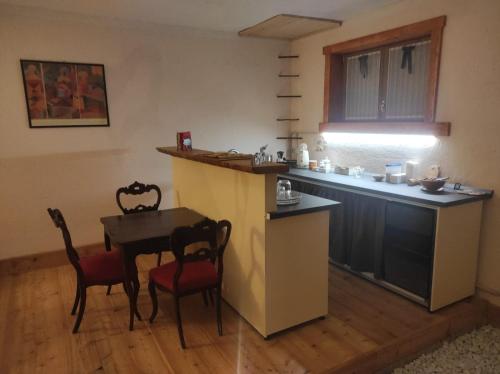 a kitchen with a table and a table and chairs at B&B Max & Lory in Neviano degli Arduini