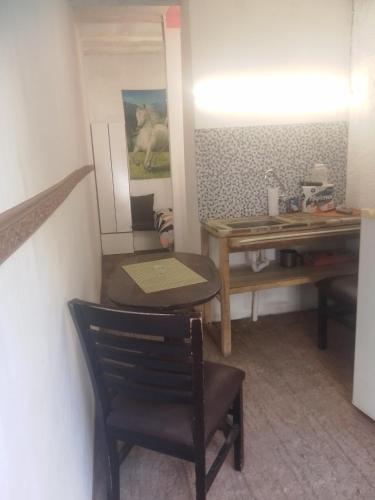 a dining room with a table and a chair at Alojamiento playa mansa 096245748 in Atlántida