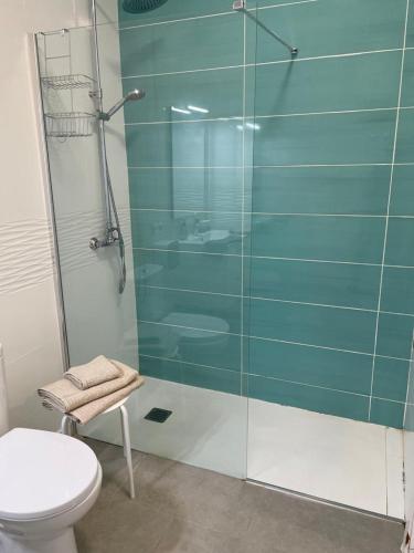 a bathroom with a glass shower and a toilet at Ocean View Sunset in Adeje