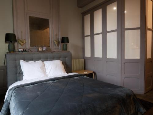 a bedroom with a bed and a sliding door at Pont Vieux Gites in Confolens