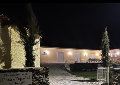 a building with a sign in front of it at night at Casa da Tapada in Torre de Moncorvo