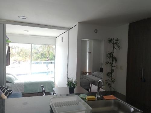 a kitchen with a sink and a living room at Apartamento en BalaBeach María Chiquita in front of the beach 2hab in Colón
