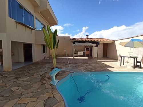 a swimming pool in front of a house at Casa de temporada in São João Batista do Glória