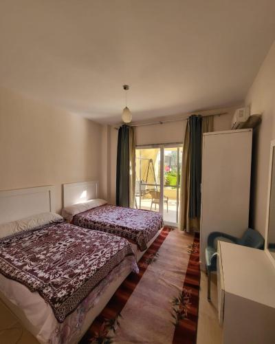 a bedroom with two beds and a window at Mousa Cost Resort عائلات فقط in Ras Sedr