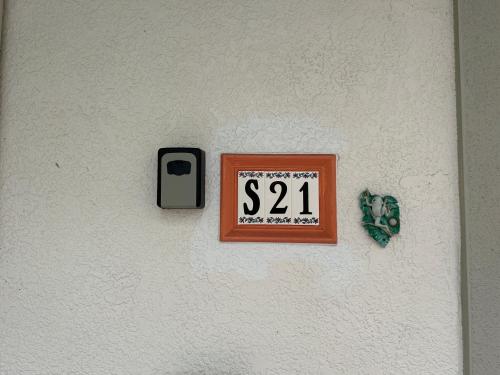 a sign on a wall with a dispenser on it at An Island Getaway at Palm Tree Villas in Holmes Beach