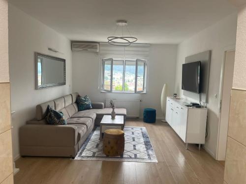 a living room with a couch and a tv at Mostar View House in Mostar