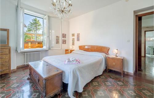 a bedroom with a bed and a table and a window at Amazing Apartment In Borghetto Di Borbera - With Wifi And 2 Bedrooms in Borghetto Di Borbera