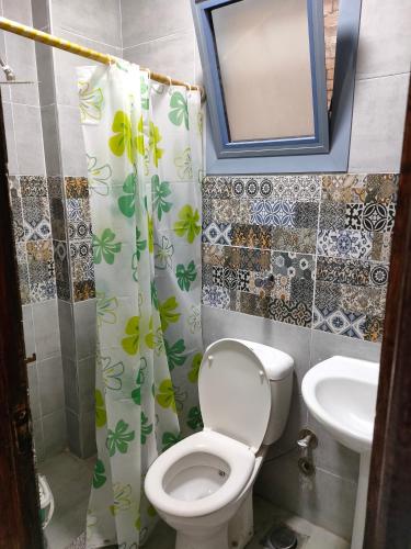 a bathroom with a toilet and a sink at Miami furnished apartment next to Khaled Bin Al Waleed in Alexandria