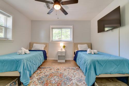 a bedroom with two beds and a ceiling fan at East Point Vacation Rental about 10 Mi to Downtown ATL in Atlanta