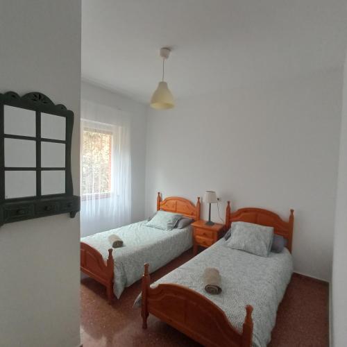 a bedroom with two beds and a window at Casa sella Asturias in Arriondas