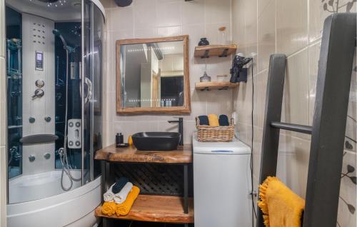 a bathroom with a sink and a toilet and a mirror at Cozy Home In Crikvenica With Kitchen in Crikvenica