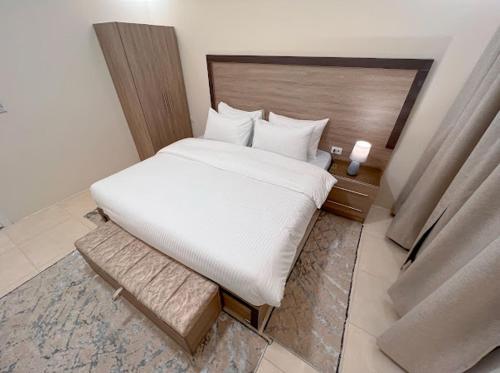 a bedroom with a large white bed in a room at Beit Alshabaan Inn in Wadi Musa
