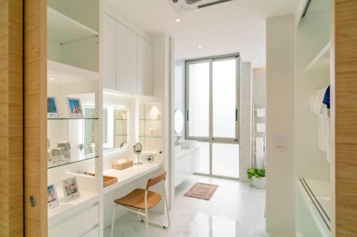 a white bathroom with a sink and a mirror at The Residence by Andaman Villa in Phuket