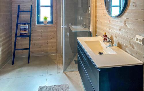 a bathroom with a sink and a shower at Nice Home In Vikes With 4 Bedrooms And Wifi in Vikeså