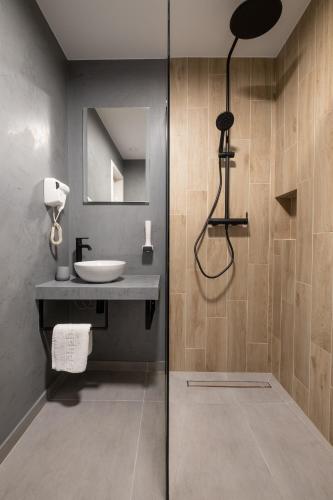 a bathroom with a sink and a glass shower door at Pensiunea Casa Georgia in Comăneşti