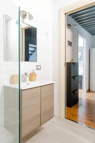 a bathroom with a sink and a mirror at Luxury Loft a Milano - Design esclusivo e comfort moderno in Milan