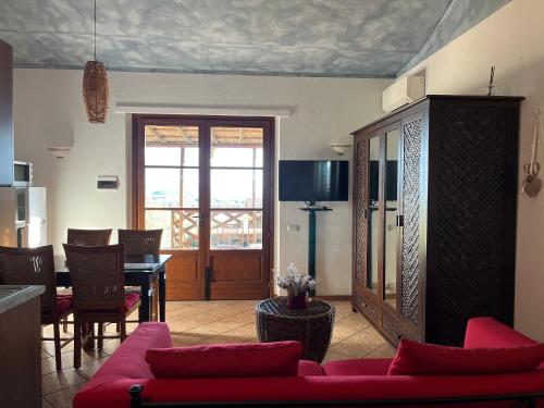 salon z czerwoną kanapą i stołem w obiekcie Agriturismo Annibale w mieście Tuoro sul Trasimeno