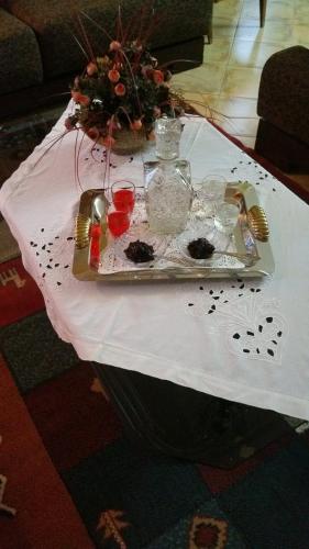 a white table with a tray of food on it at GuestHouseMantho in Gjirokastër