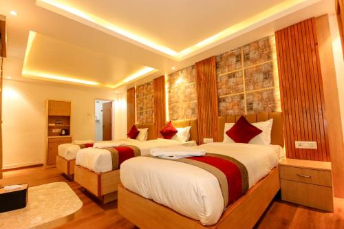 a hotel room with two beds in a room at Hotel Elegant Kathmandu Inn in Kathmandu