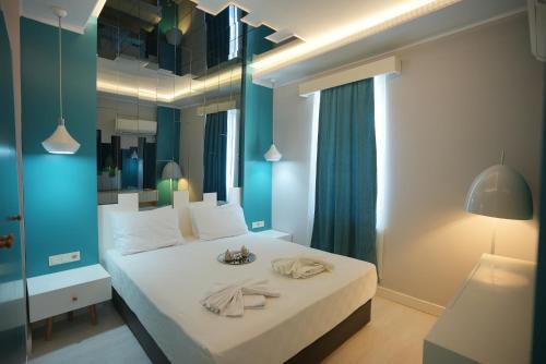 a bedroom with a large bed with towels on it at Sea Front Pansiyon in Antalya