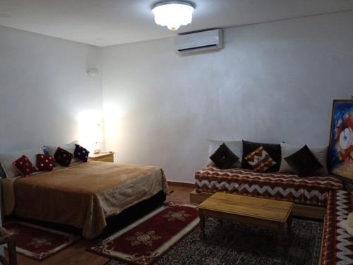 a room with a bed and a couch in it at Abla room in Azilal