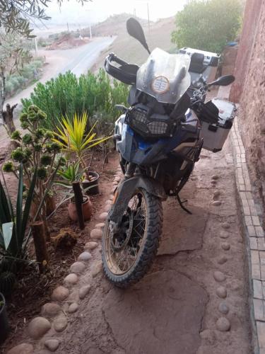 a motorcycle parked on the side of a house at Abla room in Azilal