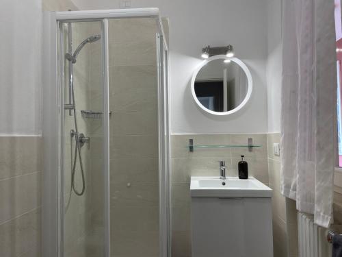 a bathroom with a shower and a sink and a mirror at Bardolino Lake Apartments in Bardolino