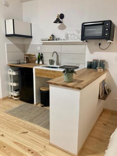 a kitchen with a sink and a counter top at studio-ville médievale-charmant in Crest