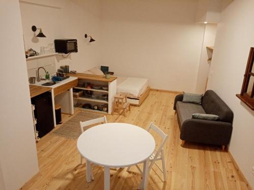 a small living room with a table and a couch at studio-ville médievale-charmant in Crest