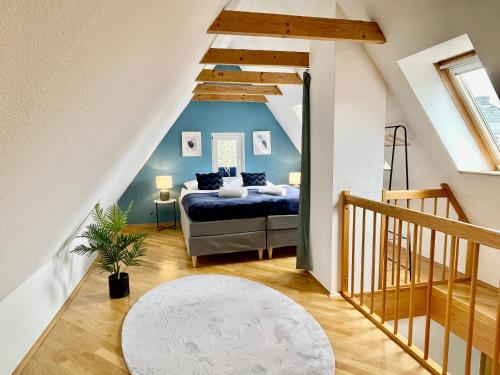 a bedroom with a bed with a blue wall at Design Maisonette I Kamin I 10 Personen I Netflix in Bremen
