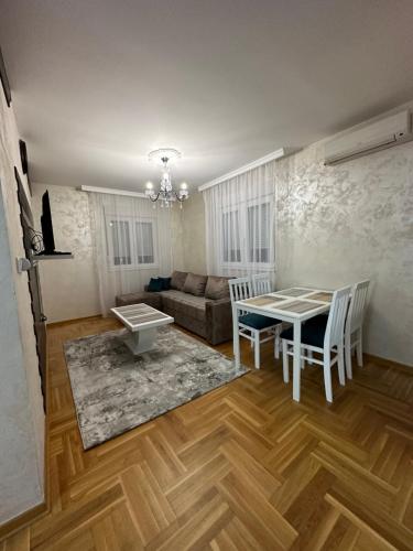 a living room with a table and chairs and a couch at Port 3 in Belgrade