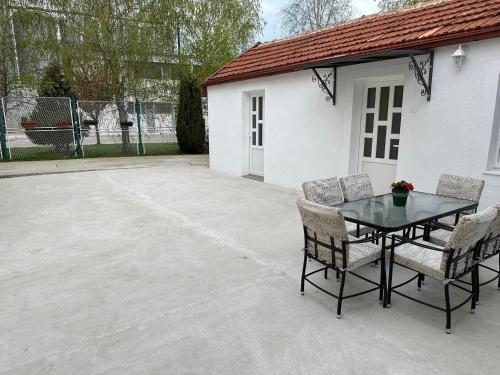 a patio with a table and chairs next to a building at Apartmani Emily & Jully in Nikšić