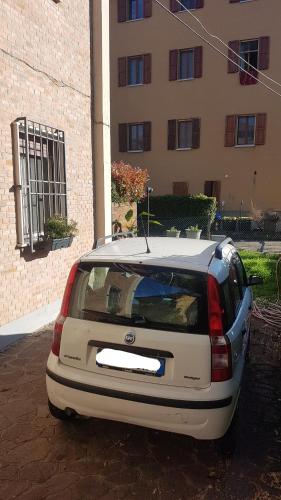 a white car parked in front of a building at Il Giardino Home in Lippo di Calderara di Reno