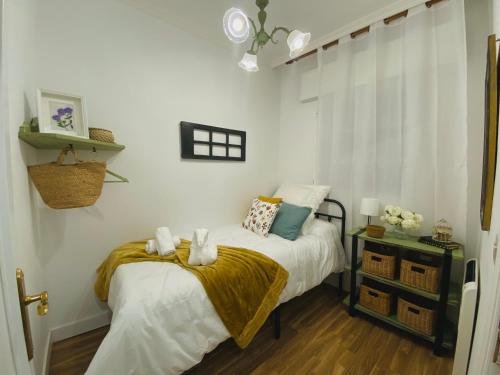 a bedroom with a bed with a yellow blanket at Bodega Sibeiro in Chantada