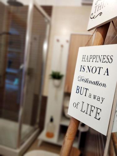 a sign that says happiness is not a destination but a way of life at Natural Charm Apartment in Rome
