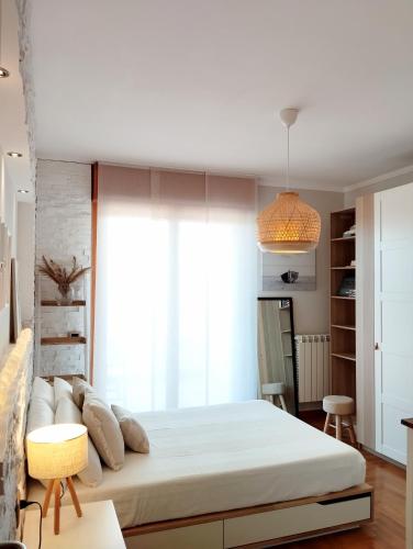 a bedroom with a large white bed and a window at Natural Charm Apartment in Rome