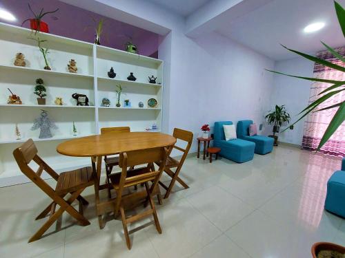 a dining room with a wooden table and chairs at Kasanty House in Paracas