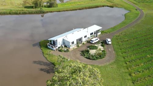 an rv parked next to a body of water at Lovedale Lakehouse Vineyard in Lovedale