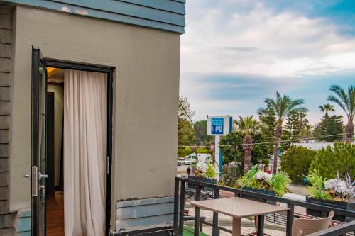 a door to a balcony with a table at Eva Hotel in Antalya